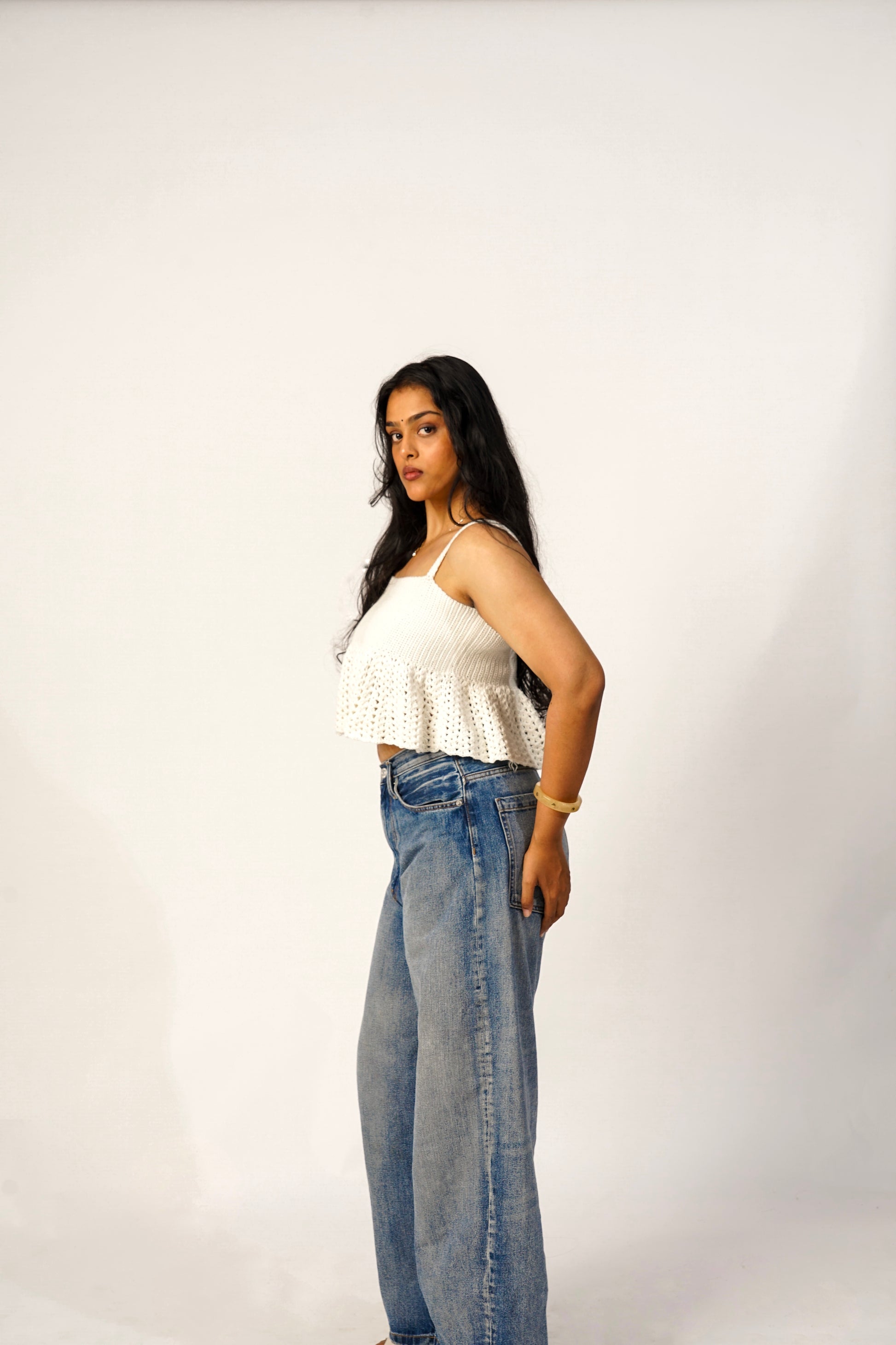Side profile of handmade ivory crochet top