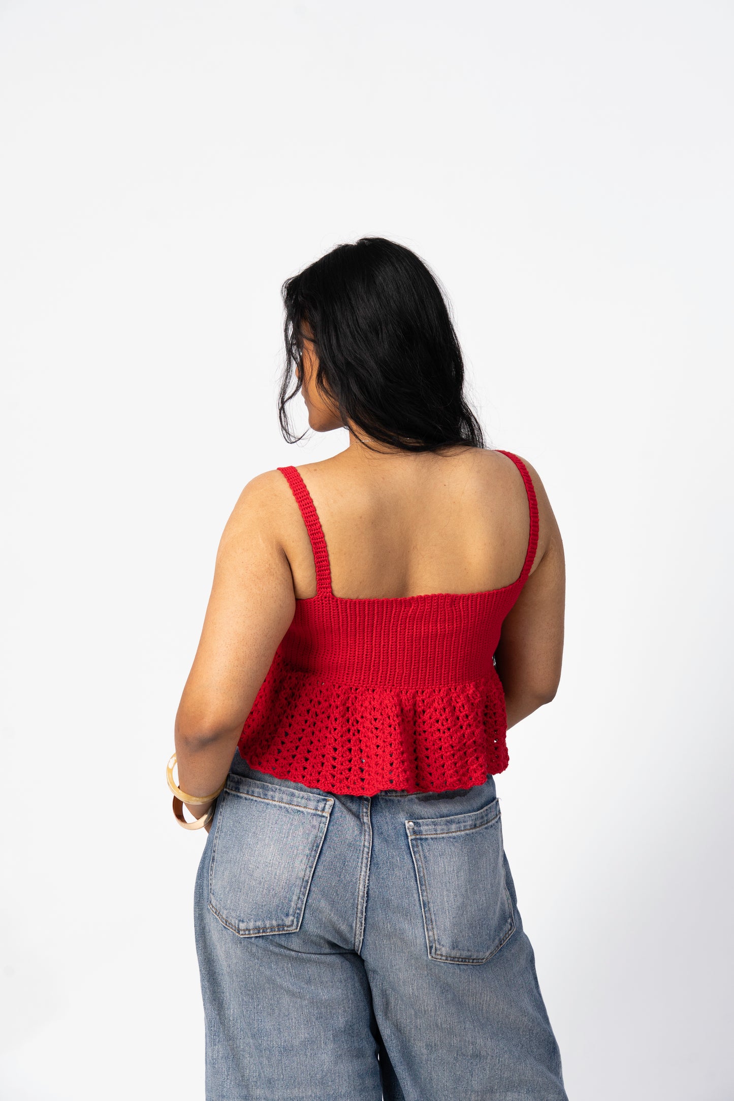 Back view of red crochet flare top with soft flared silhouette
