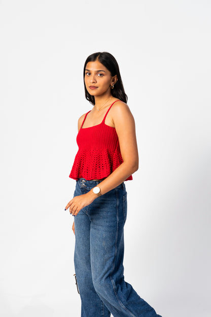 Woman wearing a red top and blue jeans on a white background