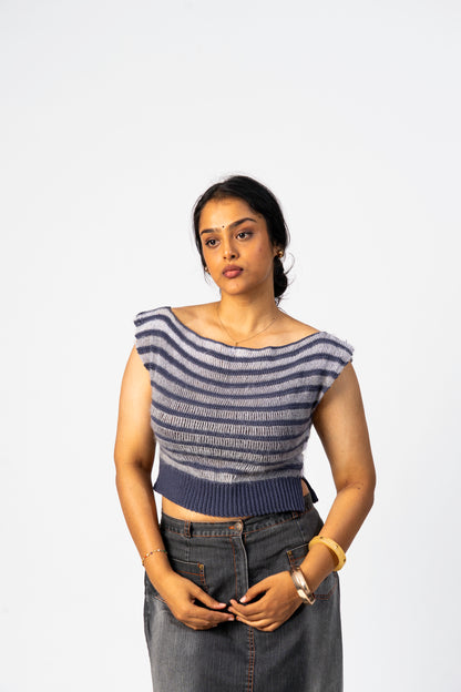 Woman wearing a striped top and jeans against a white background
