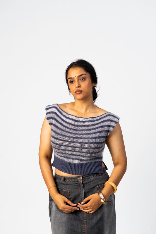 Woman wearing a striped top and jeans against a white background